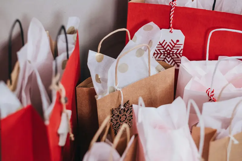 Shoppers carrying bags on a busy sale day
