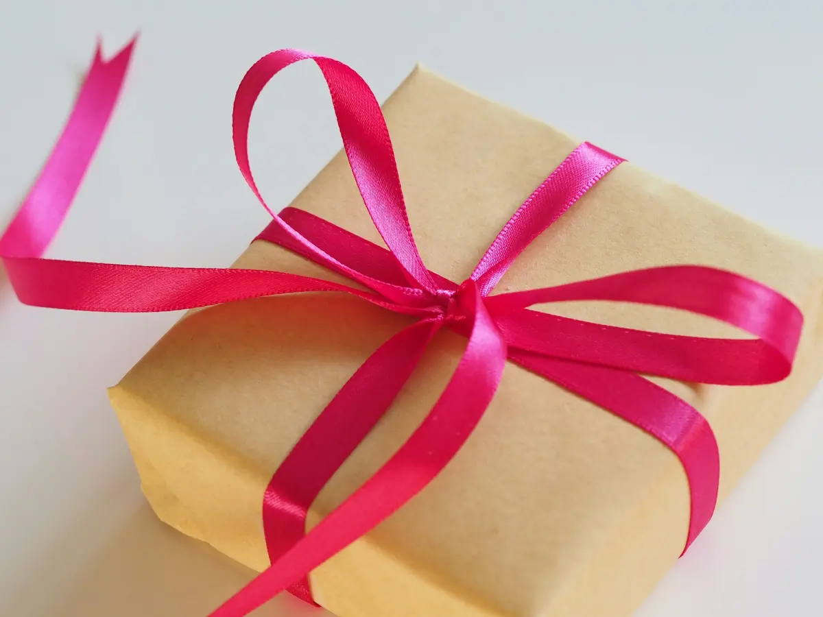 Brown gift box with a pink ribbon