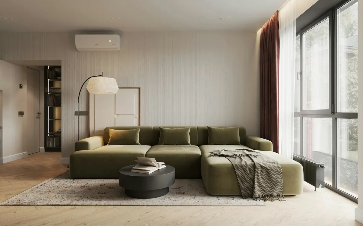 A compact living room with a large green couch