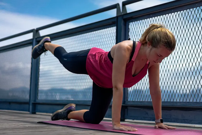 A woman doing a yoga stretch in activewear