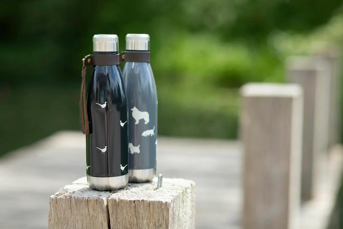Insulated water bottles on a wooden table